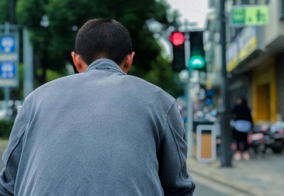 Rear view of man on street in city