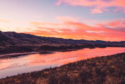 Scenic view of lake against sky during sunset