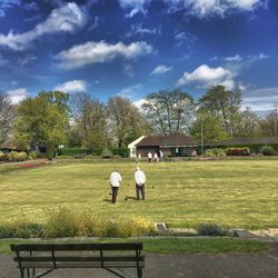 People relaxing on grassy field