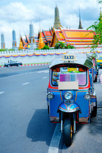 Local taxi tuk tuk parking wait tourism on street of bangkok thailand with grandpalace 