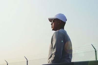 Low angle view of man standing against clear sky