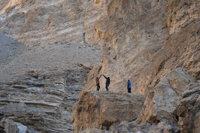 People standing on top of rocky mountains