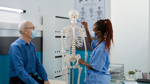 Rear view of doctor examining patient