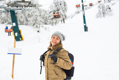 Rear view of woman standing on snow