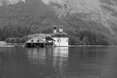 Built structure by lake against sky