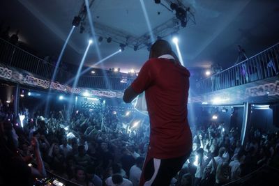 Rear view of people enjoying at music concert