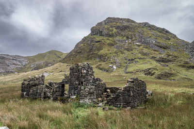 Old ruin on field against sky