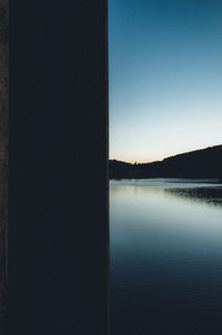 Scenic view of lake against clear blue sky