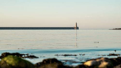 Scenic view of sea against clear sky during sunset