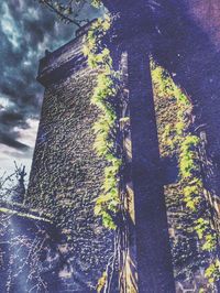 Low angle view of building against cloudy sky