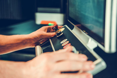 Cropped hands of man repairing computer