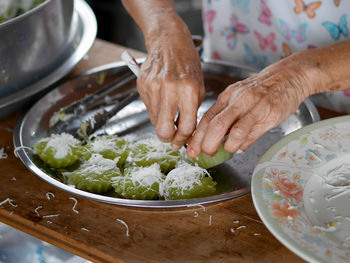 Midsection of man preparing food in kitchen