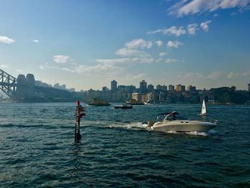 Boat on sea against sky in city