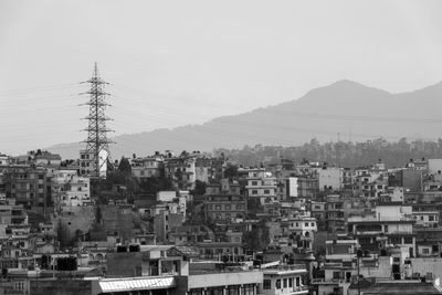 Buildings in city against clear sky