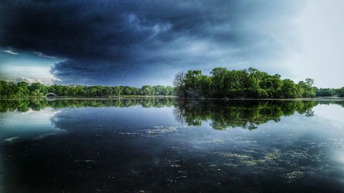 Scenic view of lake against cloudy sky