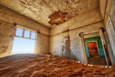 Low angle view of window in abandoned building