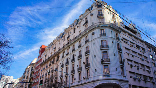 Low angle view of building against cloudy sky