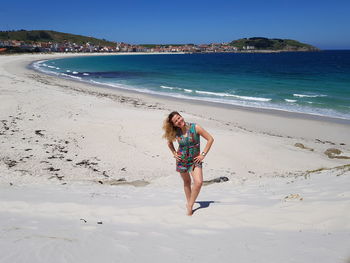 Full length of woman at beach against sky