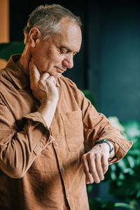 Senior man checking pulse on wristwatch