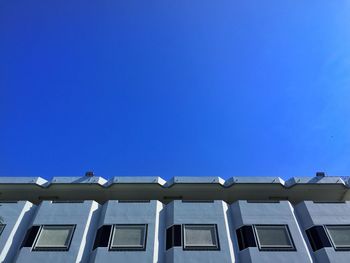 Low angle view of building against clear blue sky