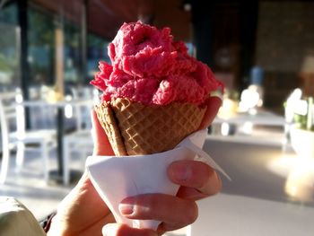 Close-up of hand holding ice cream cone