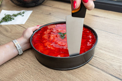 Cropped hand of person holding food on table