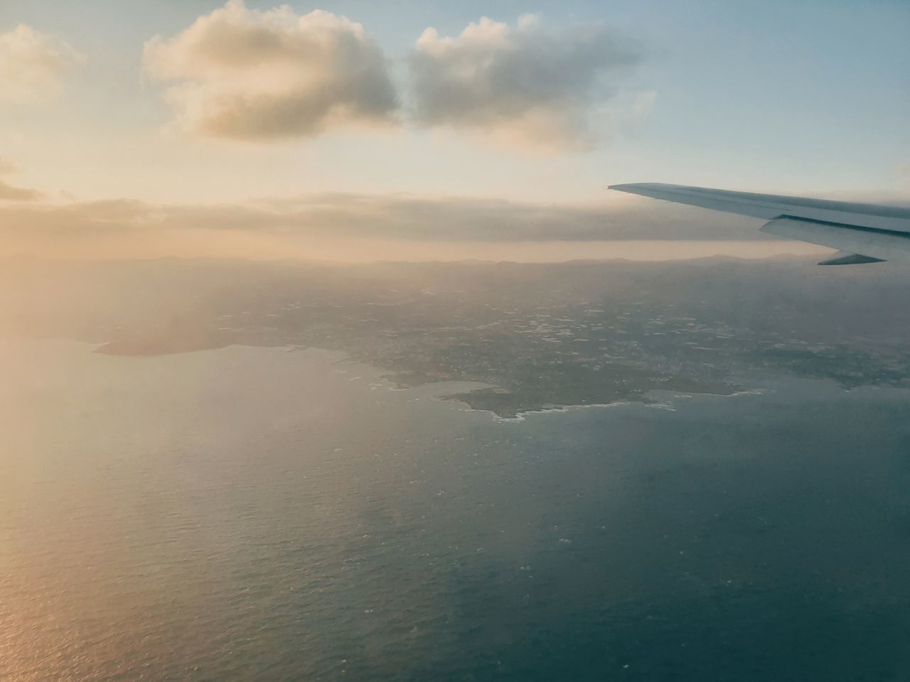 AERIAL VIEW OF SEA AND AIRPLANE AGAINST SKY