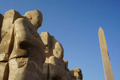 Low angle view of statue against blue sky