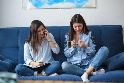 Small business with needlework. two girls talking on the phone with customers and knits. 