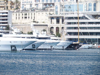 Boats moored at harbor in city