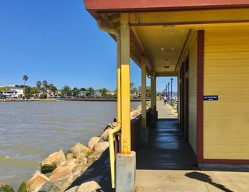 Bridge over sea against buildings in city