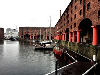 Boats in river with buildings in background