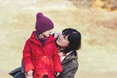 Happy mother and daughter in nature. family, parenting and healthy relationship concept