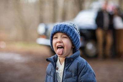Portrait of happy boy in park during winter