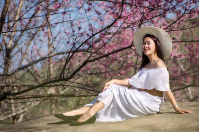 Full length of woman sitting at park