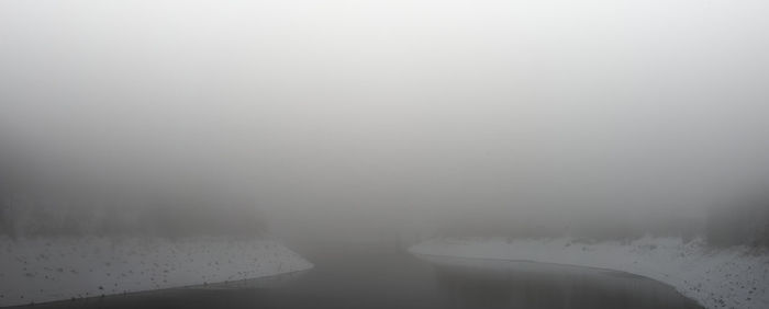 Scenic view of landscape against sky during winter