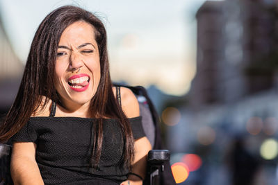 Portrait of young woman using mobile phone