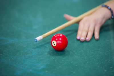 Woman playing pool on table