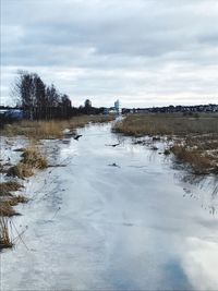 Scenic view of frozen lake against sky during winter