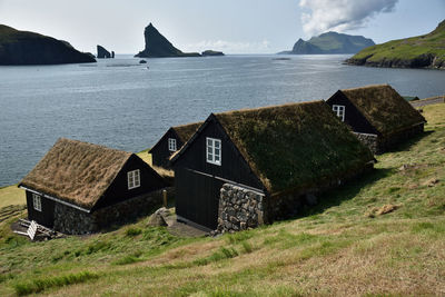 Scenic view of sea and houses against sky