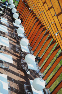 High angle view tables and chairs arranged at sidewalk cafe