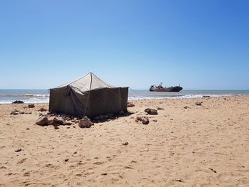 Scenic view of beach against clear blue sky