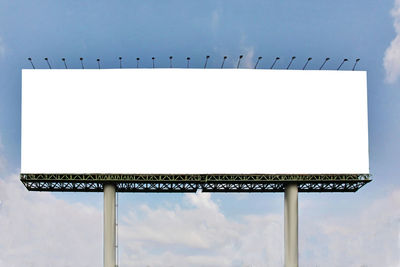 Low angle view of empty sign against sky