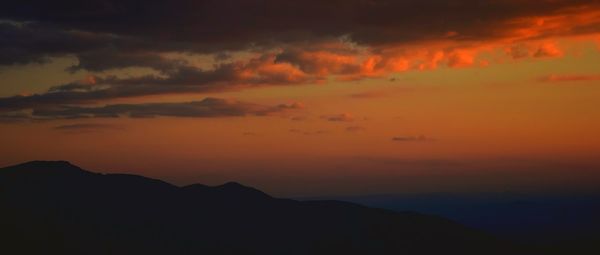 Scenic view of mountains against sky at sunset