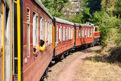 Kalka shimla toy train moving on mountain slopes, beautiful view, one side mountain, one side valley