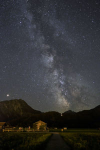 Scenic view of mountains against sky at night