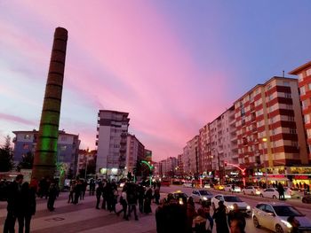 Crowd in city at sunset