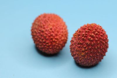 Close-up of strawberries on table against blue background
