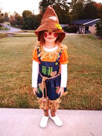 Full length portrait of girl wearing costume standing on walkway