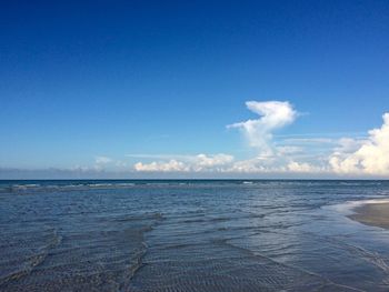 Scenic view of sea against blue sky